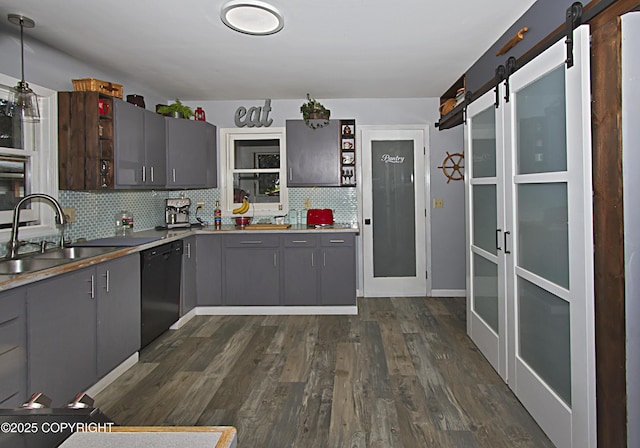 213 Lee Dr, Homer, AK 99603 - kitchen with black dishwasher, gray cabinetry, a barn door, backsplash, and dark wood-style flooring