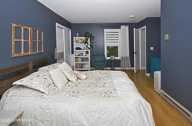 213 Lee Dr, Homer, AK 99603 - bedroom featuring baseboard heating and wood finished floors