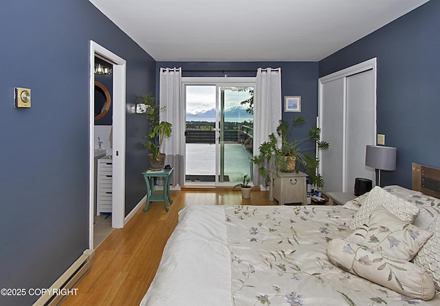 213 Lee Dr, Homer, AK 99603 - bedroom with access to exterior, wood finished floors, and a closet