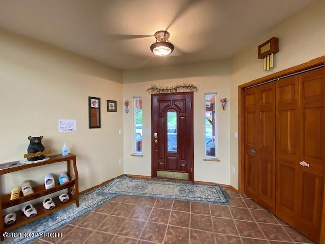 60871 Bear Creek Dr, Homer, AK 99603 - foyer entrance featuring ceiling fan and dark tile patterned flooring