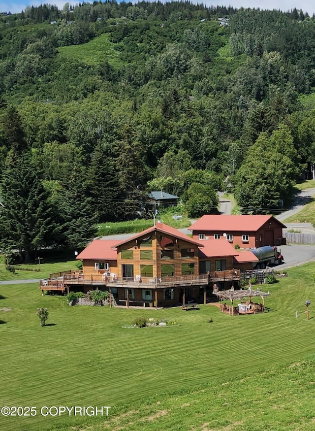 60871 Bear Creek Dr, Homer, AK 99603 - view of property's community with a wooded view, a yard, and a wooden deck