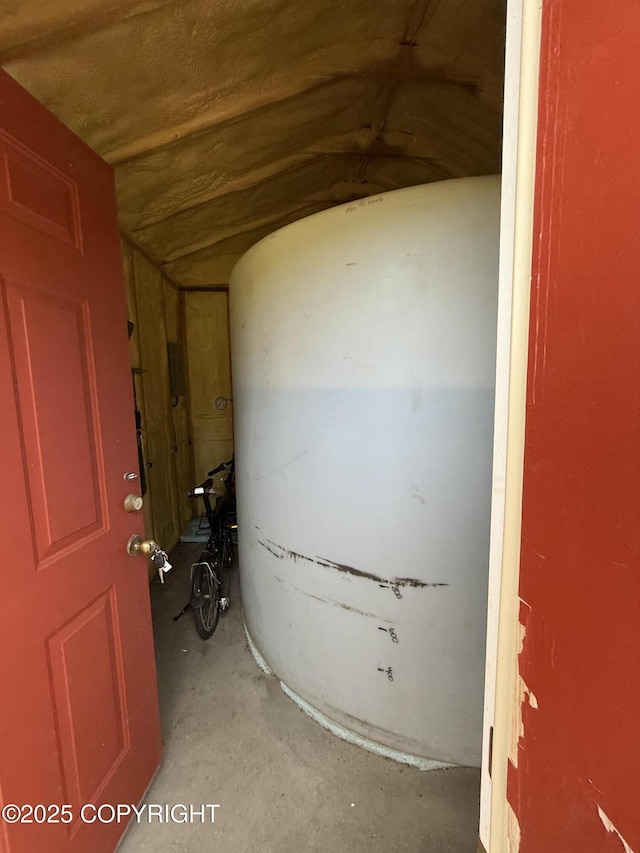 60871 Bear Creek Dr, Homer, AK 99603 - detailed view of unfinished concrete flooring and a water pressure tank