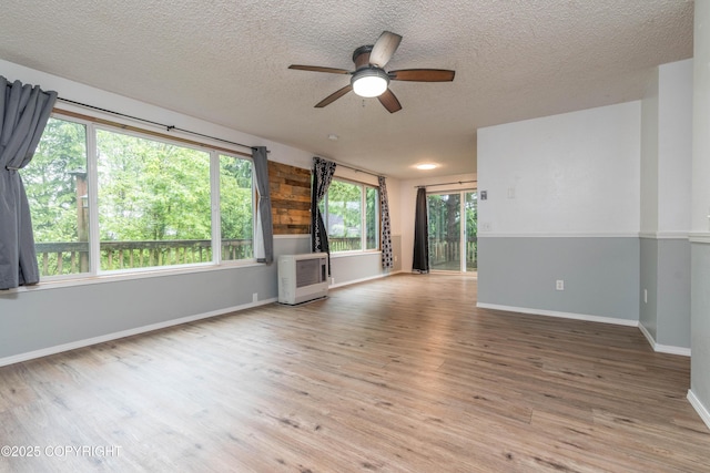 3237 Lincoln Ct, Ketchikan, AK 99901 - unfurnished living room featuring a ceiling fan, wood finished floors, and a textured ceiling