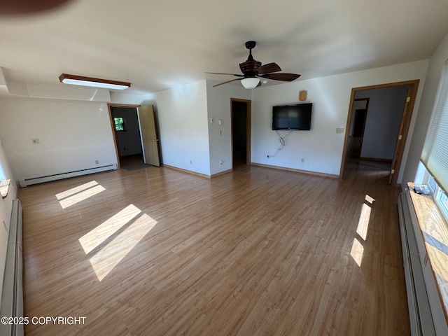 16297 E Harter Dr, Palmer, AK 99645 - unfurnished living room featuring a baseboard heating unit, baseboard heating, and light wood-style floors
