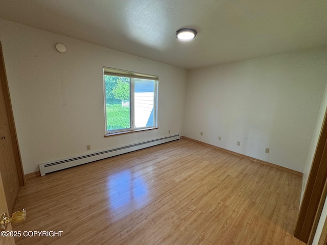 16297 E Harter Dr, Palmer, AK 99645 - spare room featuring baseboard heating and light wood-type flooring
