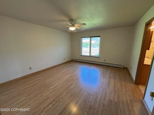 16297 E Harter Dr, Palmer, AK 99645 - empty room featuring a baseboard heating unit, wood finished floors, and ceiling fan