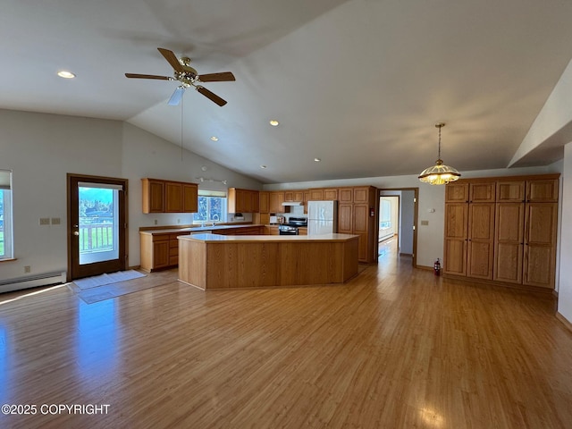16297 E Harter Dr, Palmer, AK 99645 - kitchen featuring freestanding refrigerator, light countertops, light wood-type flooring, a center island, and a ceiling fan