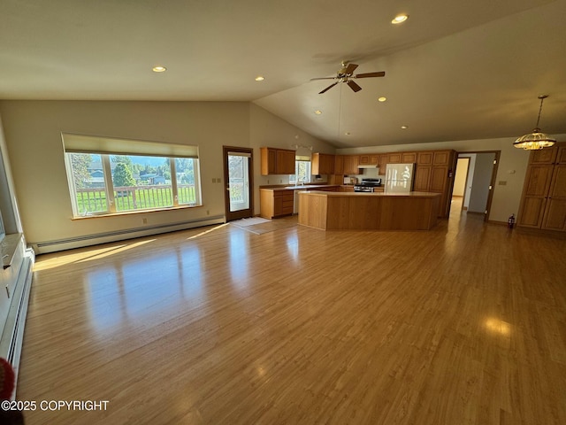 16297 E Harter Dr, Palmer, AK 99645 - unfurnished living room with a baseboard heating unit, lofted ceiling, ceiling fan, light wood finished floors, and recessed lighting
