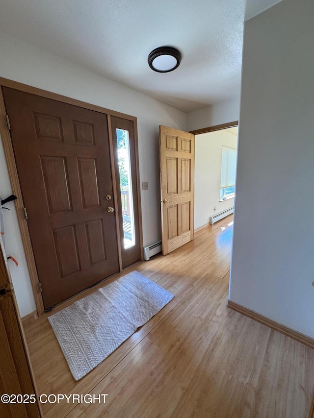 16297 E Harter Dr, Palmer, AK 99645 - foyer entrance featuring a baseboard radiator and light wood finished floors