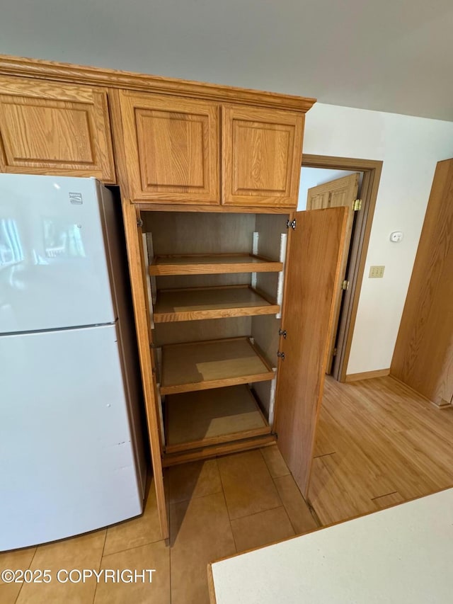 16297 E Harter Dr, Palmer, AK 99645 - kitchen view of freestanding refrigerator and baseboards