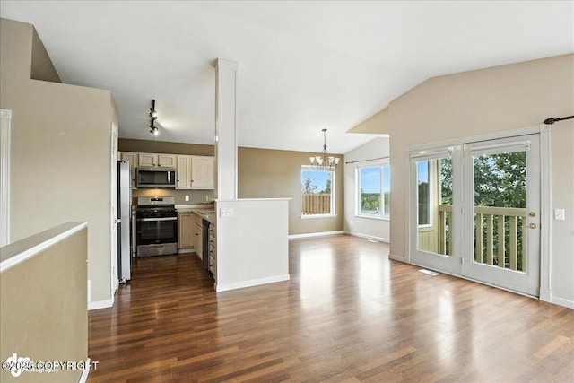 10300 Ridge Park Dr, Anchorage, AK 99507 - kitchen featuring appliances with stainless steel finishes, a chandelier, dark wood-type flooring, a peninsula, and vaulted ceiling