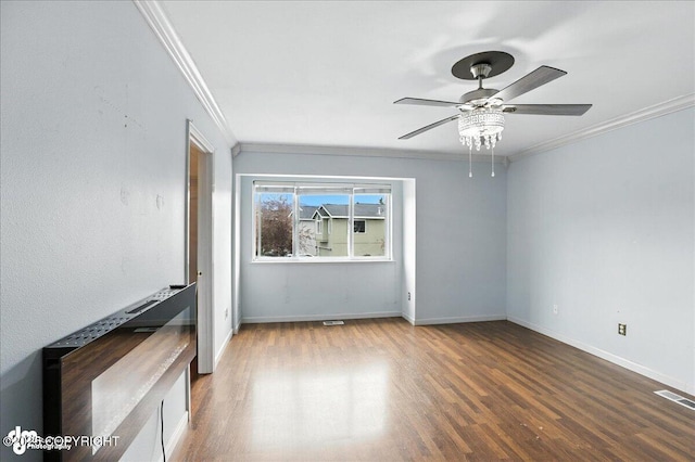 10300 Ridge Park Dr, Anchorage, AK 99507 - spare room featuring ornamental molding, ceiling fan, and wood finished floors