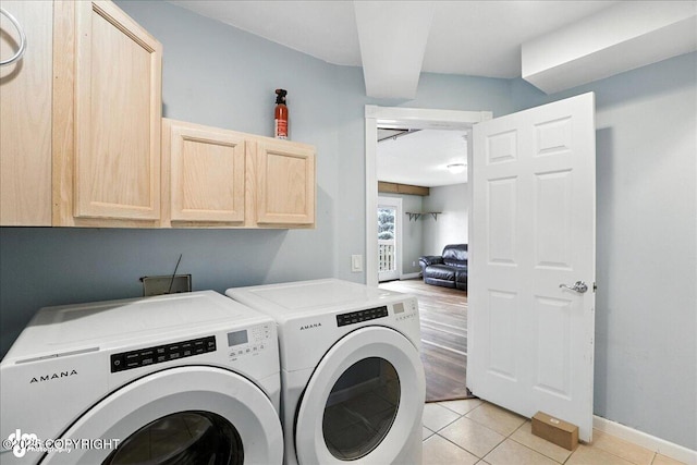 10300 Ridge Park Dr, Anchorage, AK 99507 - washroom with independent washer and dryer, cabinet space, and light tile patterned floors