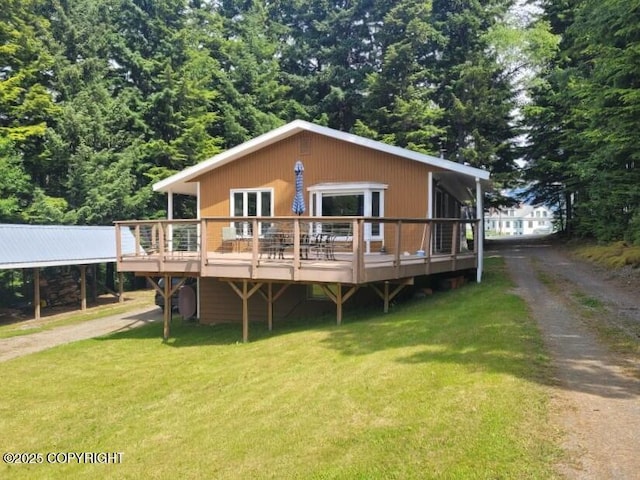 385 S 3rd Ave, Haines, AK 99827 - view of front of house featuring a deck, a front yard, and dirt driveway