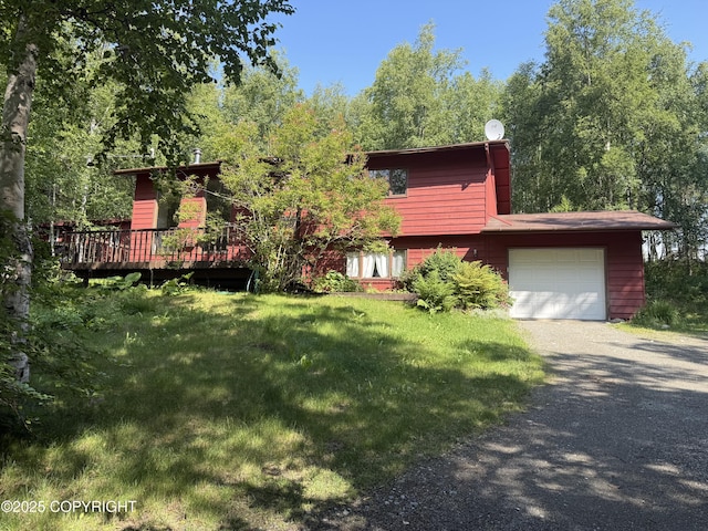 4261 E Foxtrot Ave, Wasilla, AK 99654 - view of front facade featuring driveway, a front lawn, a deck, and a garage
