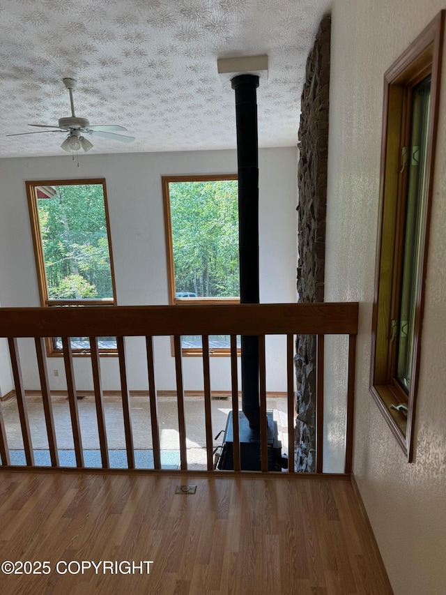 4261 E Foxtrot Ave, Wasilla, AK 99654 - detailed view of wood finished floors, ceiling fan, a textured ceiling, and a textured wall