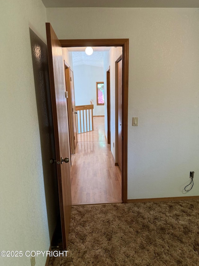 4261 E Foxtrot Ave, Wasilla, AK 99654 - hall with carpet floors, an upstairs landing, and wood finished floors