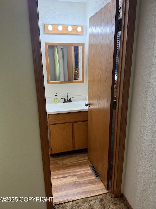 4261 E Foxtrot Ave, Wasilla, AK 99654 - bathroom with vanity and a textured wall