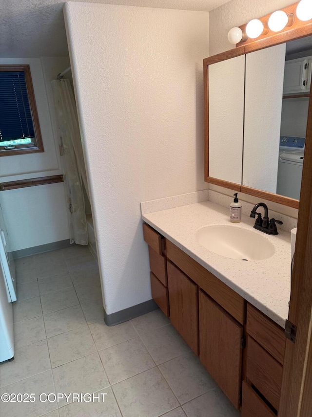 4261 E Foxtrot Ave, Wasilla, AK 99654 - bathroom featuring washer / dryer, vanity, tile patterned flooring, and a shower with shower curtain