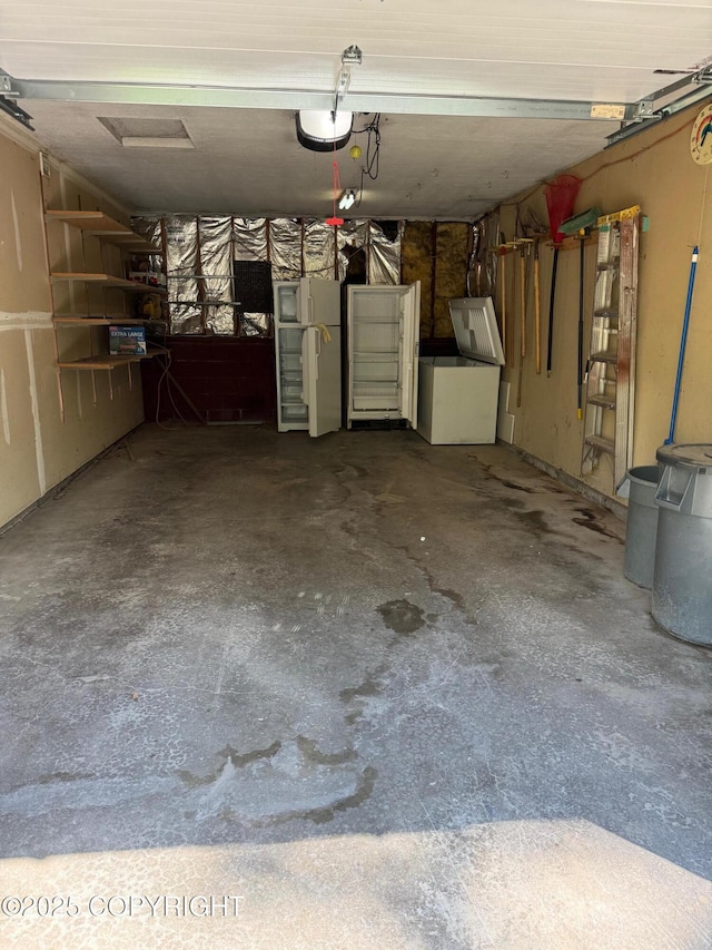 4261 E Foxtrot Ave, Wasilla, AK 99654 - garage with fridge and a garage door opener
