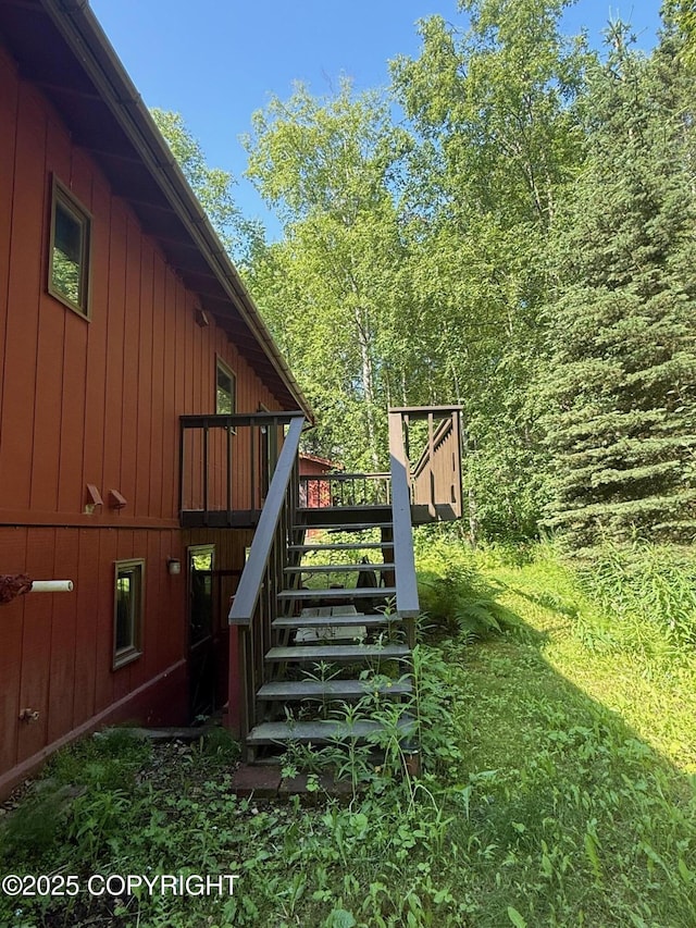 4261 E Foxtrot Ave, Wasilla, AK 99654 - view of home's exterior with stairs, a wooden deck, and board and batten siding