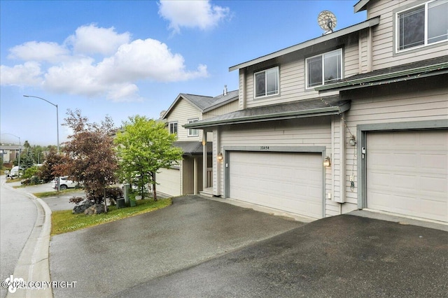 20454 Icefall Dr, Eagle River, AK 99577 - view of side of property with an attached garage and driveway