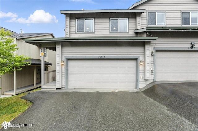 20454 Icefall Dr, Eagle River, AK 99577 - view of front of house featuring a garage and asphalt driveway