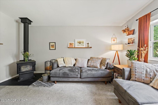 2701 Julie Ln, North Pole, AK 99705 - carpeted living room featuring a wood stove and baseboards