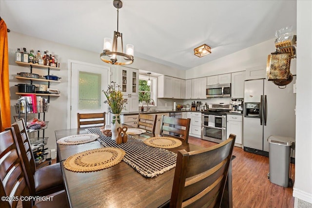 2701 Julie Ln, North Pole, AK 99705 - dining space featuring a chandelier, wood finished floors, and lofted ceiling