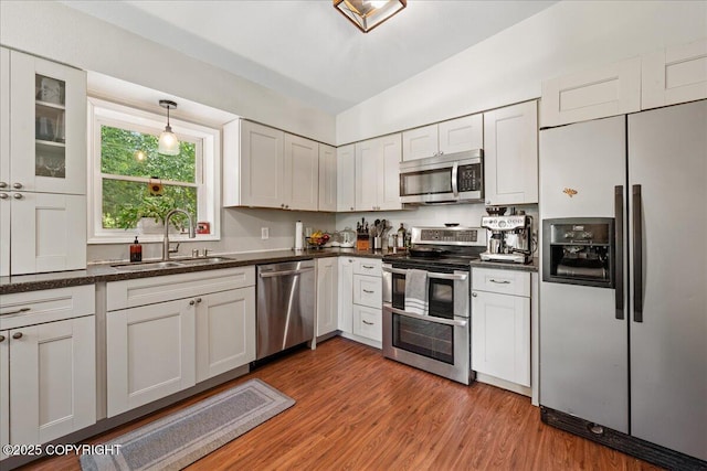 2701 Julie Ln, North Pole, AK 99705 - kitchen featuring appliances with stainless steel finishes, light wood-style floors, decorative light fixtures, and white cabinets