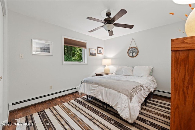2701 Julie Ln, North Pole, AK 99705 - bedroom with a baseboard heating unit, wood finished floors, and ceiling fan