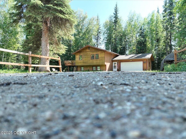 2701 Julie Ln, North Pole, AK 99705 - view of front facade with a garage and a view of trees