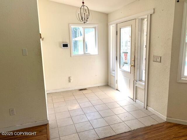 7367 S Rubacaba St, Wasilla, AK 99623 - foyer entrance with a chandelier, plenty of natural light, and light tile patterned floors