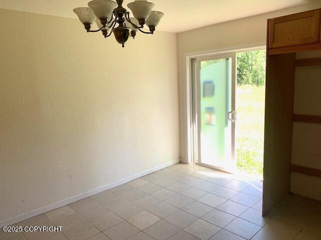 7367 S Rubacaba St, Wasilla, AK 99623 - empty room with a chandelier and light tile patterned floors