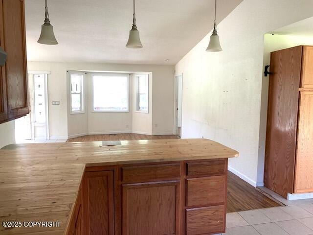 7367 S Rubacaba St, Wasilla, AK 99623 - kitchen featuring pendant lighting, brown cabinets, wooden counters, and a peninsula
