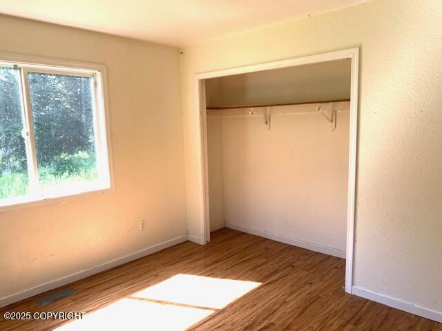 7367 S Rubacaba St, Wasilla, AK 99623 - unfurnished bedroom with a closet and wood finished floors