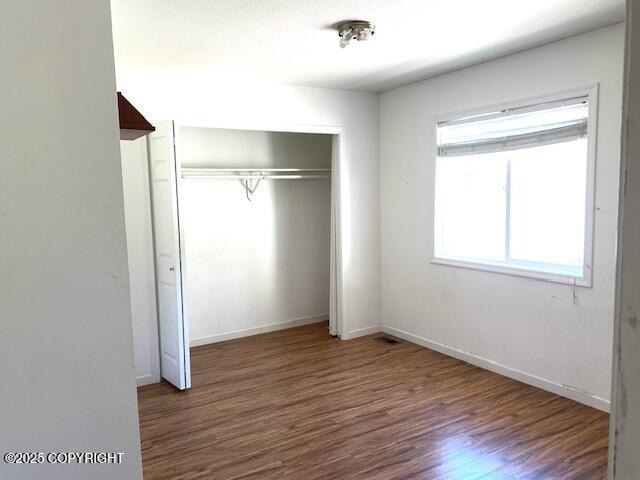 7367 S Rubacaba St, Wasilla, AK 99623 - unfurnished bedroom featuring wood finished floors and a closet