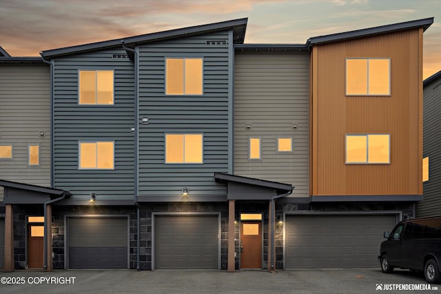 11459 Moonrise Ridge Pl # 7, Anchorage, AK 99516 - townhome / multi-family property with a garage and stone siding