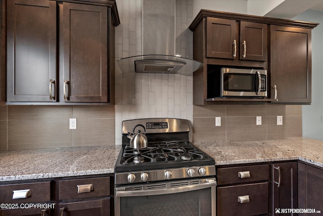 11459 Moonrise Ridge Pl # 7, Anchorage, AK 99516 - kitchen featuring appliances with stainless steel finishes, wall chimney range hood, dark brown cabinetry, and tasteful backsplash