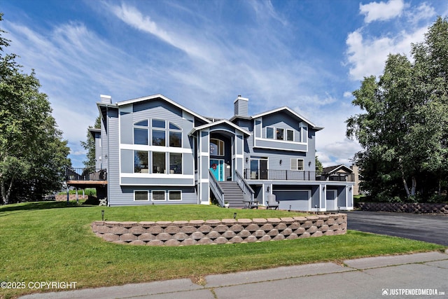 2231 Shore Dr, Anchorage, AK 99515 - view of front of property with a chimney, driveway, stairs, and a front lawn