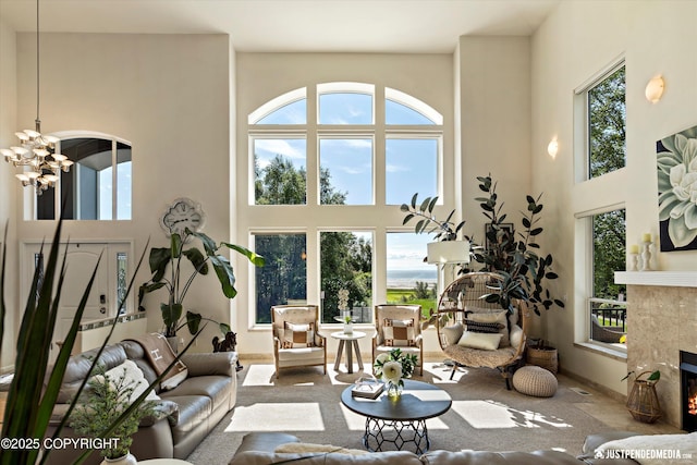2231 Shore Dr, Anchorage, AK 99515 - living room with a high ceiling, a tiled fireplace, and a chandelier