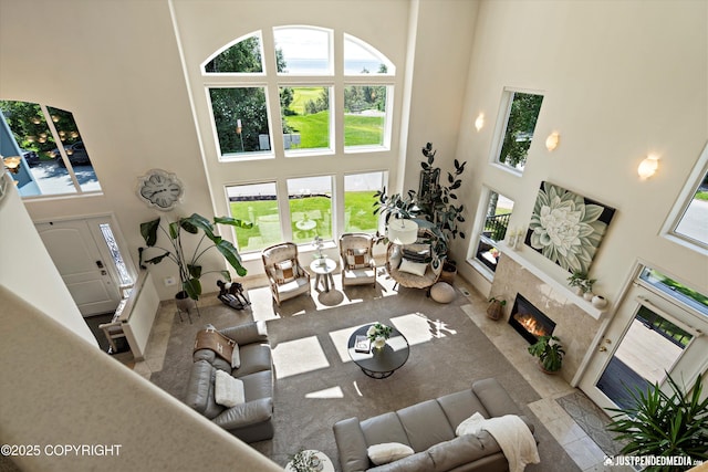 2231 Shore Dr, Anchorage, AK 99515 - living area featuring a high ceiling, a high end fireplace, and healthy amount of natural light