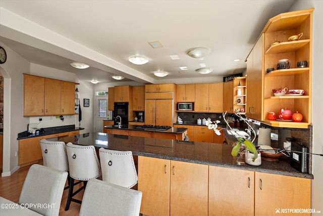 2231 Shore Dr, Anchorage, AK 99515 - kitchen with built in appliances, open shelves, a peninsula, arched walkways, and wood finished floors