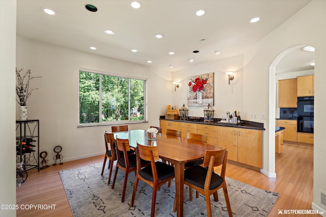 2231 Shore Dr, Anchorage, AK 99515 - dining room featuring recessed lighting, light wood finished floors, and arched walkways