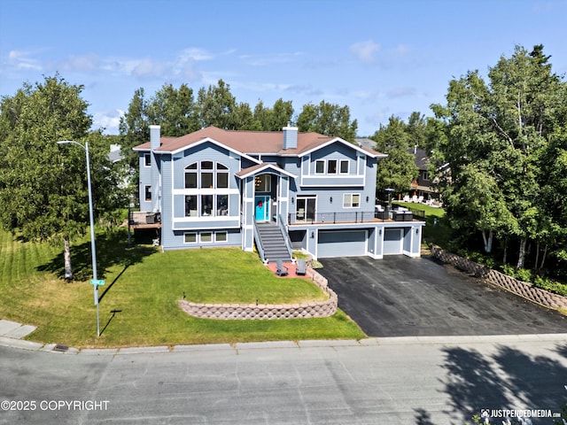 2231 Shore Dr, Anchorage, AK 99515 - raised ranch with stairs, asphalt driveway, a chimney, and an attached garage