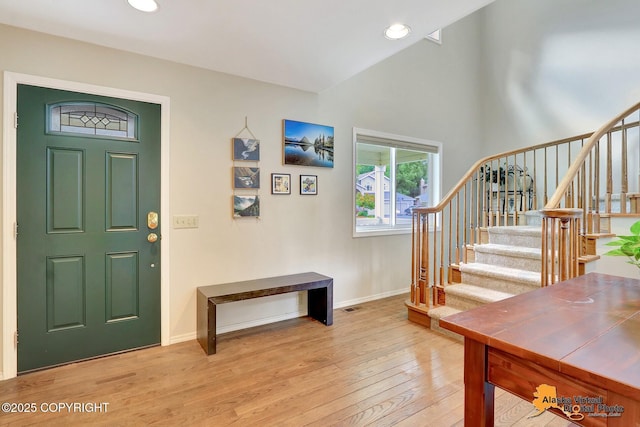 7521 Labrador Cir, Anchorage, AK 99502 - entrance foyer with light wood-type flooring, stairway, recessed lighting, and vaulted ceiling