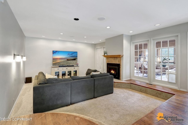 7521 Labrador Cir, Anchorage, AK 99502 - living area with recessed lighting, a tiled fireplace, and wood finished floors