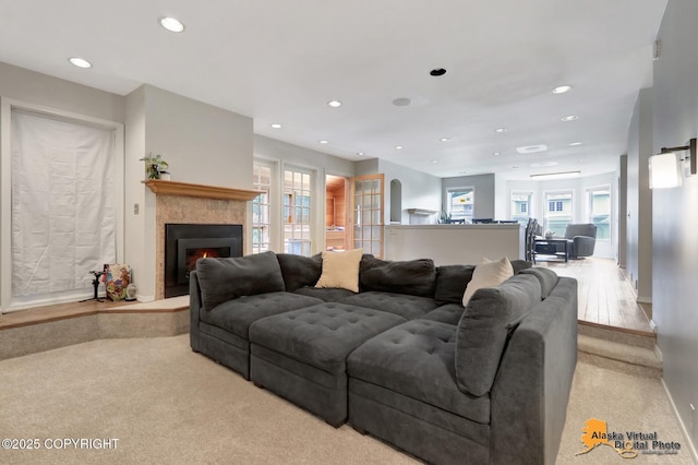 7521 Labrador Cir, Anchorage, AK 99502 - living room with carpet, recessed lighting, and a lit fireplace