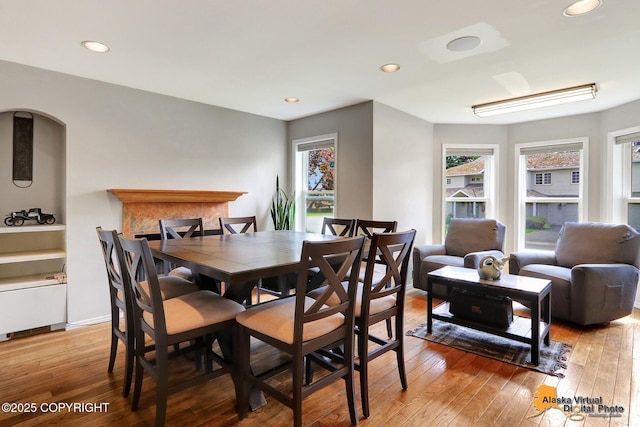 7521 Labrador Cir, Anchorage, AK 99502 - dining room featuring light wood-style flooring, recessed lighting, and arched walkways