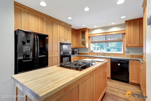 7521 Labrador Cir, Anchorage, AK 99502 - kitchen featuring black appliances, butcher block counters, recessed lighting, glass insert cabinets, and light wood-style floors